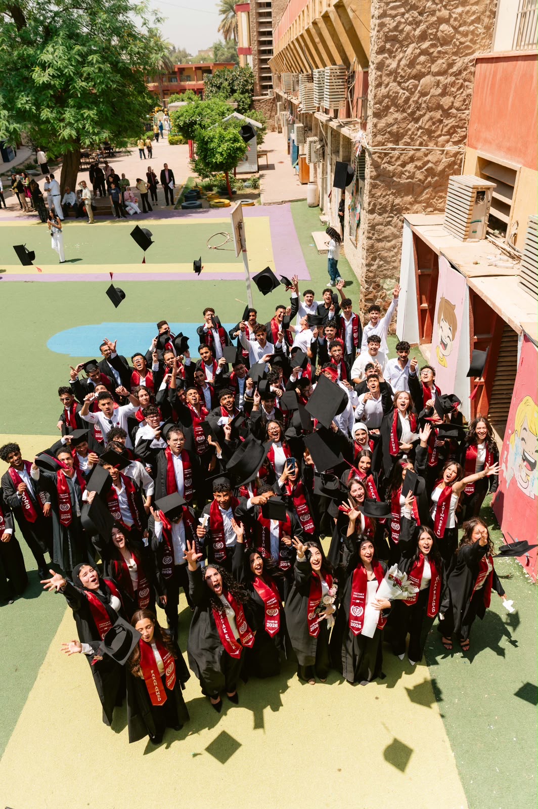 Class of 2026 celebrating with caps in the air
